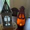 A handmade spooky pumpkin gourd to with an extra large mouth. This ghostly pumpkin is decorating a dining room table.